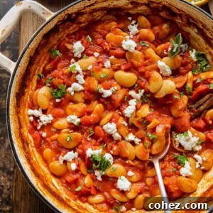 Pan of butter bean stew in a pot with spoon