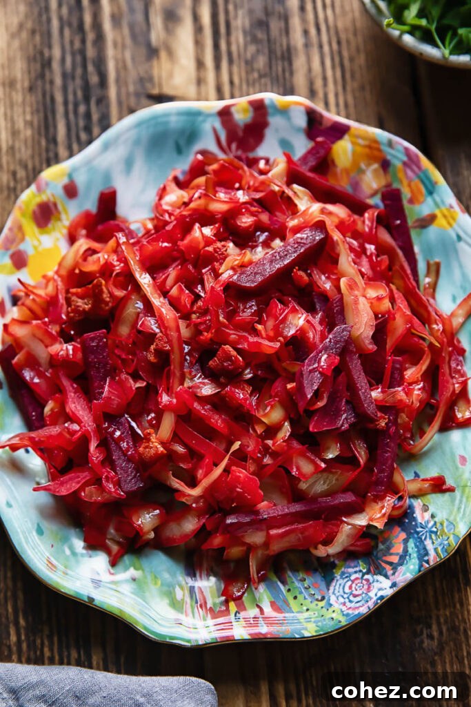 Top down shot of a large serving of braised cabbage and beets on a small blue plate