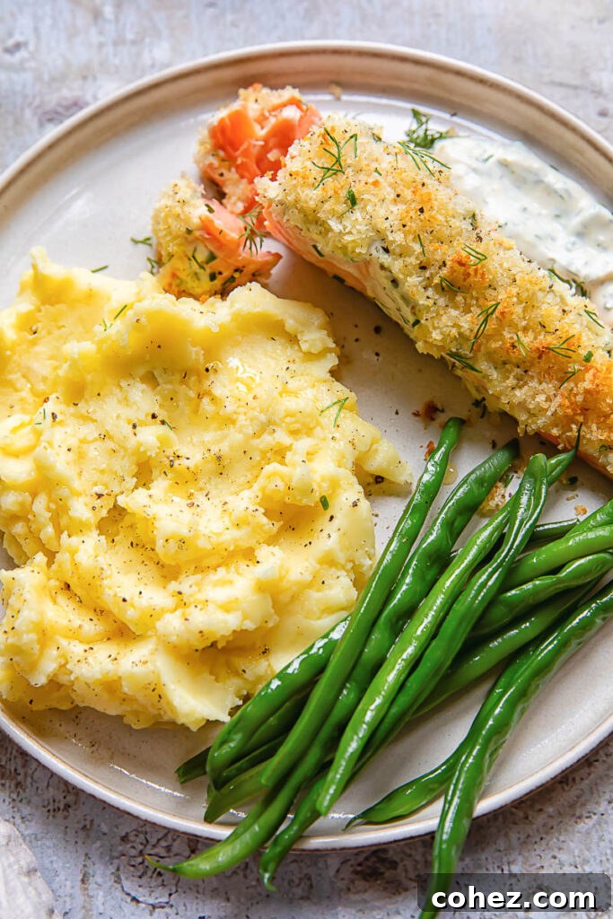 Golden Baked Garlic Herb Salmon with Panko Crunch 3 Top-down shot of a single baked salmon fillet on a baking sheet, showcasing the golden Panko breadcrumb crust and herb-infused topping.