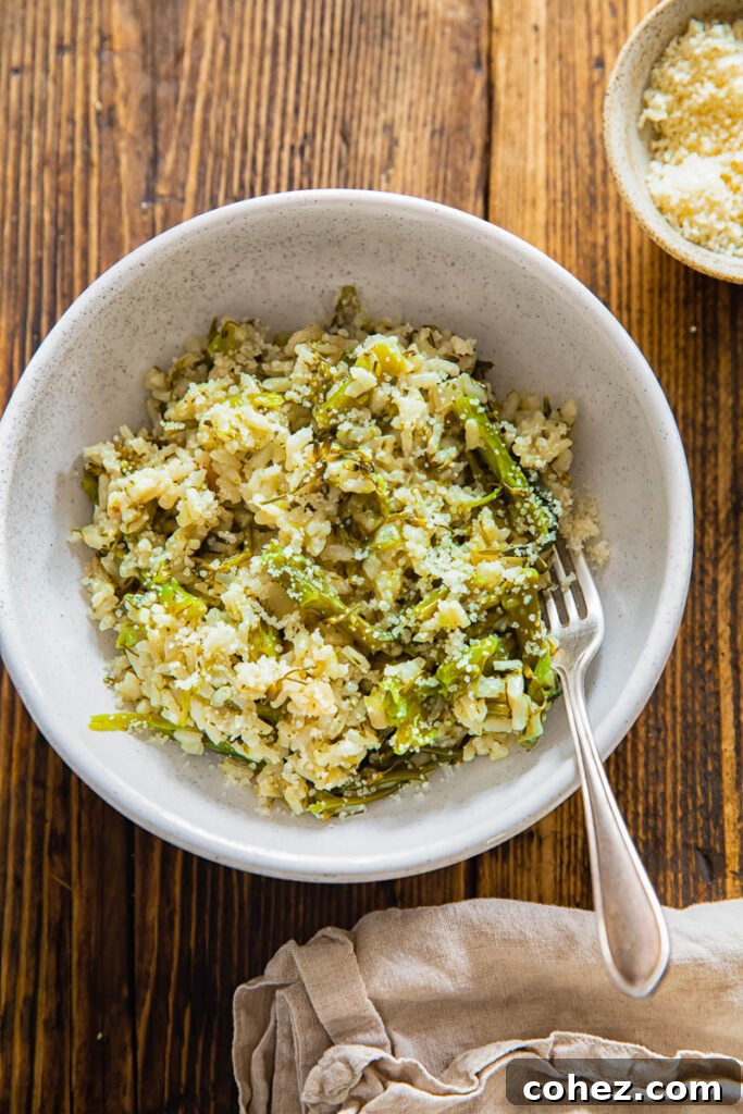 Top down view of a rustic bowl filled with creamy Instant Pot risotto, generously studded with vibrant green broccoli florets. Steam gently rises from the comforting dish.