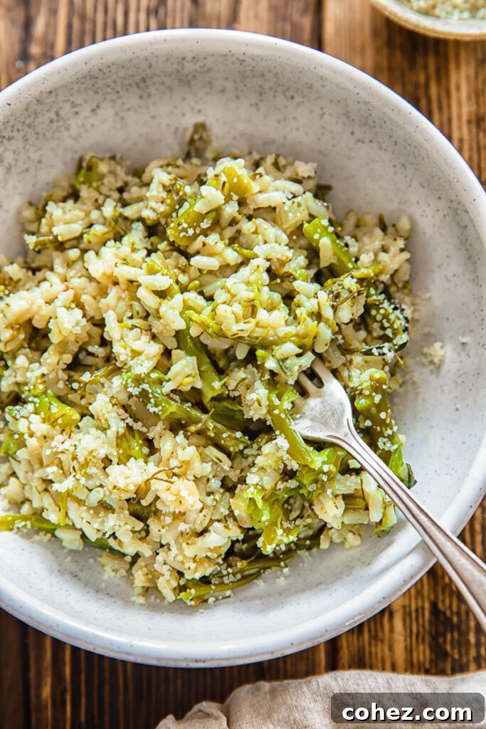 Close-up of a small, elegant bowl of Instant Pot risotto with broccoli, garnished with fresh herbs, and a fork ready to scoop into the creamy dish.