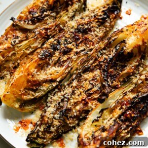 Gochujang Cabbage with Golden Crunch 6 Close up shot of roasted cabbage on a plate, quartered and topped with breadcrumbs