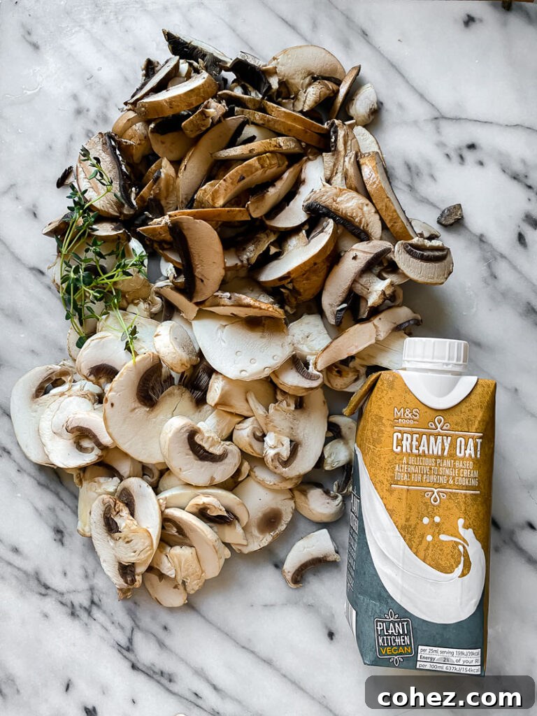 Assorted fresh mushrooms and a container of oat cream beautifully arranged on a rustic wooden table, ready for soup preparation.