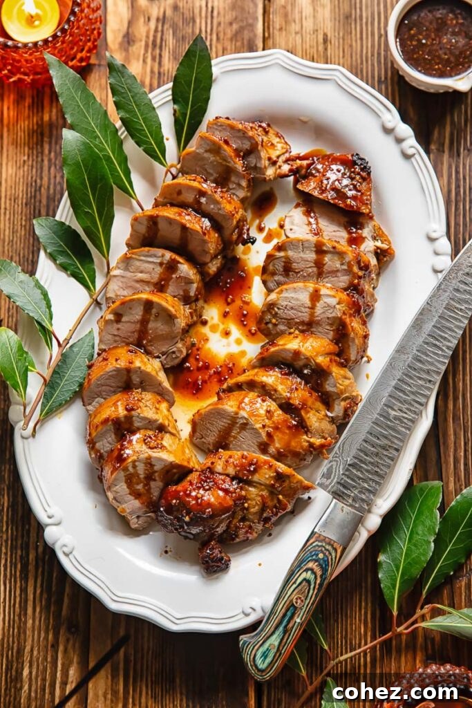 Slices of pork tenderloin lined up on an oval plate