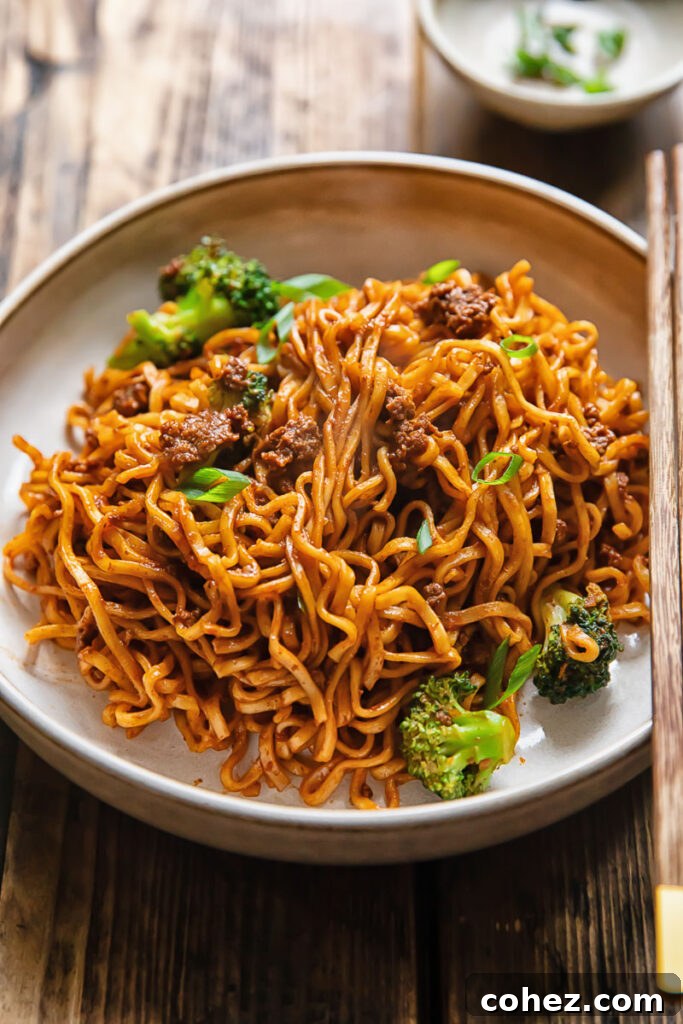 Side shot of gochujang noodles in a wide bowl on a table