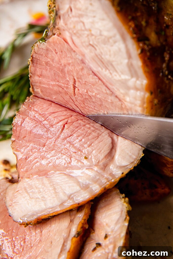 Tender Roast Leg of Lamb with Bright Mint Sauce 2 side view of roast lamb being sliced