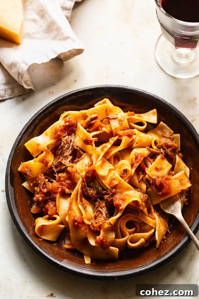 Top down shot of short rib ragu on a plate with a fork