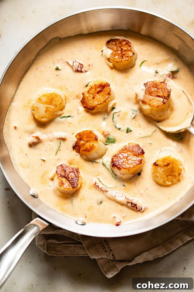 Top down shot of marry me scallops in a pan with sun-dried tomatoes and basil