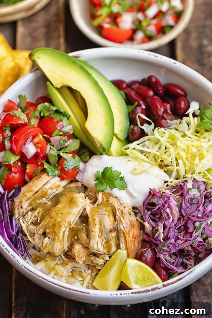 Fiesta Chicken Burrito Bowl 4 Close up shot of chicken burrito bowl topped with pico de gallo, slaw and avocado