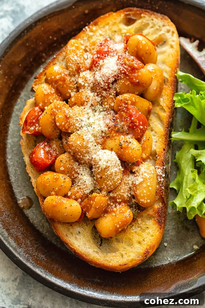 Top down shot of butter beans in tomato sauce on toast