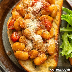 Top down shot of butter beans in tomato sauce on toast