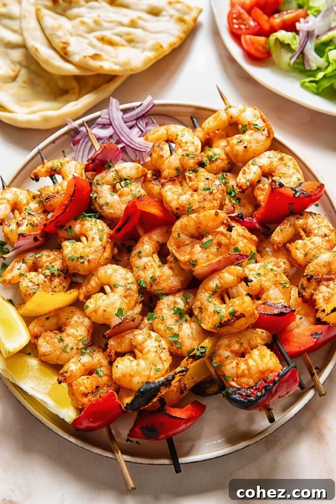 Lemon Garlic Grilled Shrimp Skewers 2 Shrimp kebabs skewers stacked on top of each other on a plate