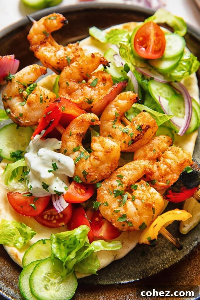 Lemon Garlic Grilled Shrimp Skewers 3 Close up shot of shrimp kebab on pita with salad