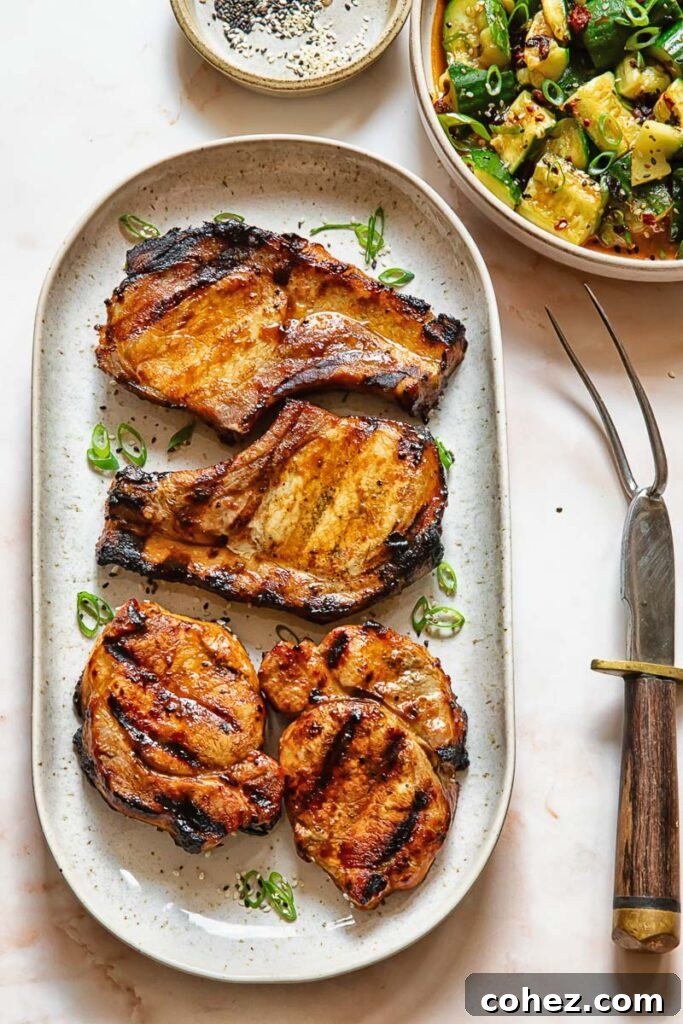 Flame Kissed Teriyaki Pork Chops 2 Top down shot of grilled teriyaki pork chops on a serving platter