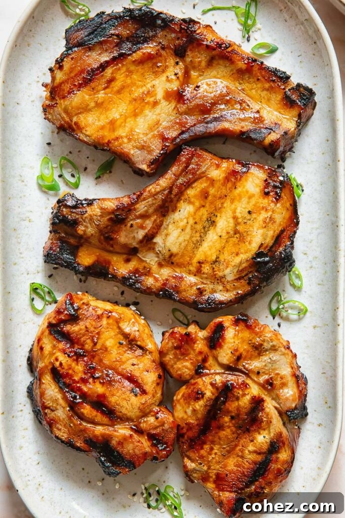 Flame Kissed Teriyaki Pork Chops 4 Teriyaki pork chops lined up on a plate