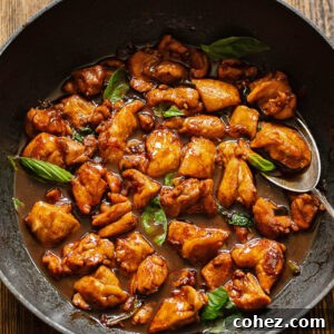 Top down shot of three cup chicken in a pan