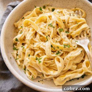 Top-down view of Fettuccine Alfredo with fresh parsley garnish
