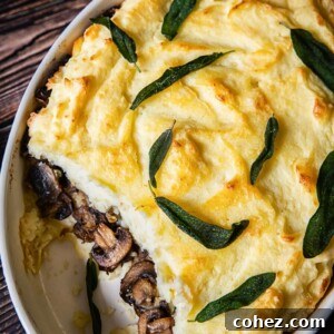 Mashed potato casserole with a visible middle layer of sautéed mushrooms and caramelized onions, topped with a golden crust.