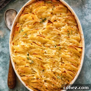 Top-down view of a rectangular baking dish filled with creamy scalloped potatoes layered with caramelized shallots and a golden-brown crust.