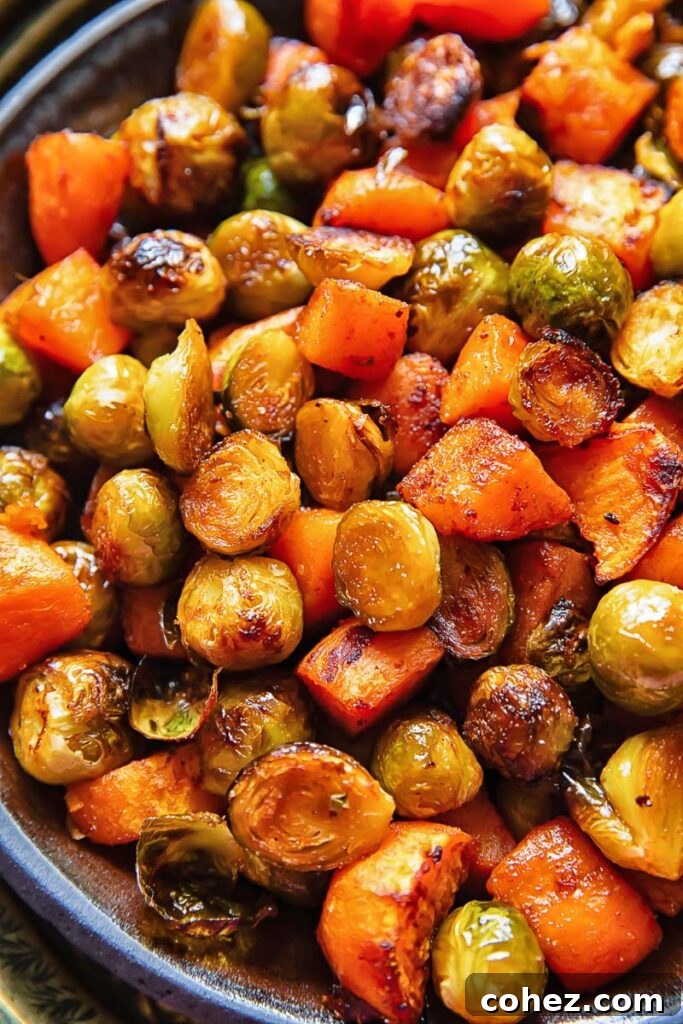 Close up of perfectly roasted Brussels sprouts and sweet potatoes in a large bowl
