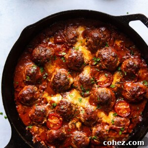 Baked meatballs topped with melted mozzarella and fresh arugula, a perfect Italian-inspired meal.