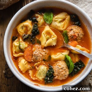 A hearty bowl of tortellini soup, brimming with vegetables and chicken meatballs.