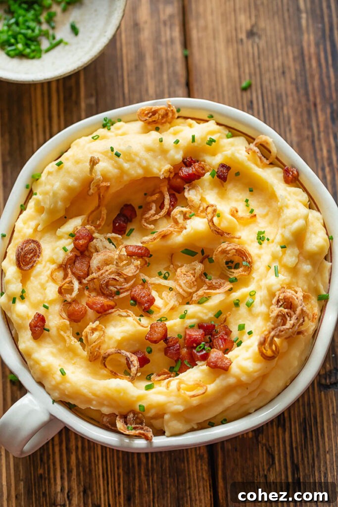 Cheesy mashed potatoes with crispy shallots in a bowl