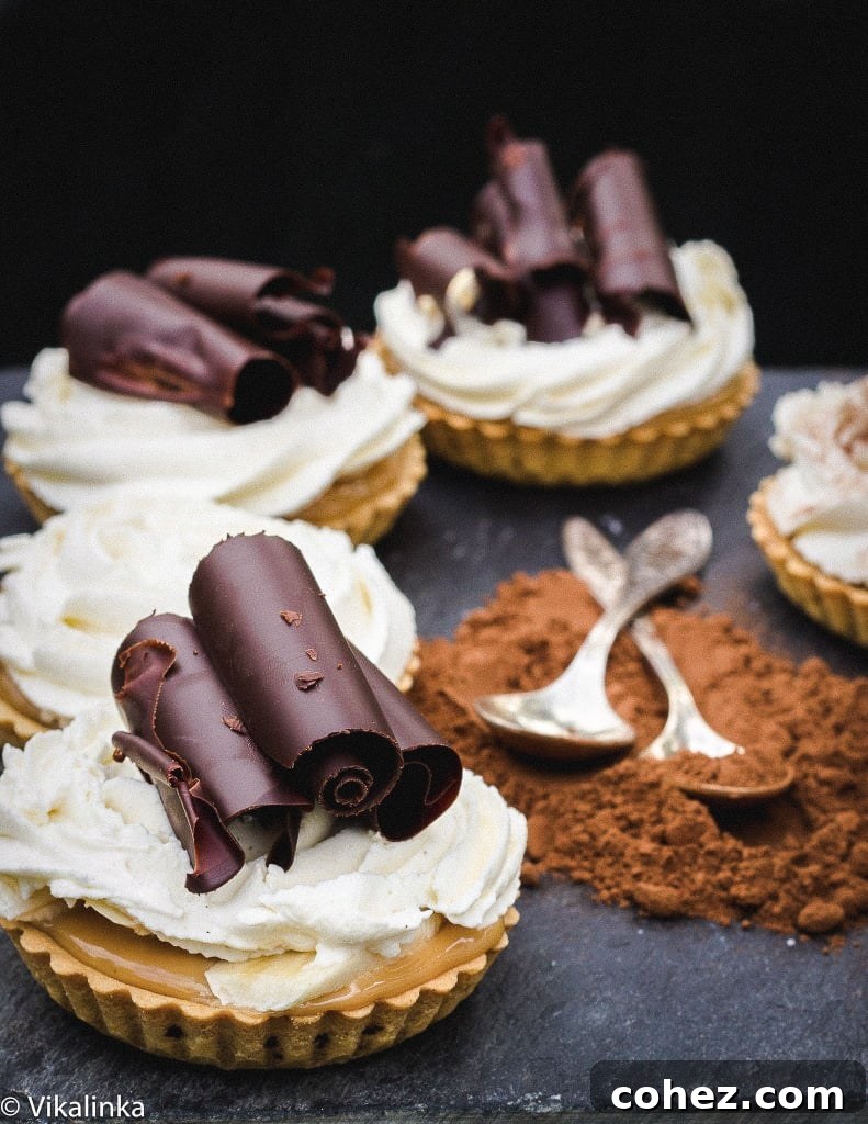 Close-up of multiple banoffee tarts arranged in a circular pattern, highlighting their intricate chocolate curls and creamy tops.
