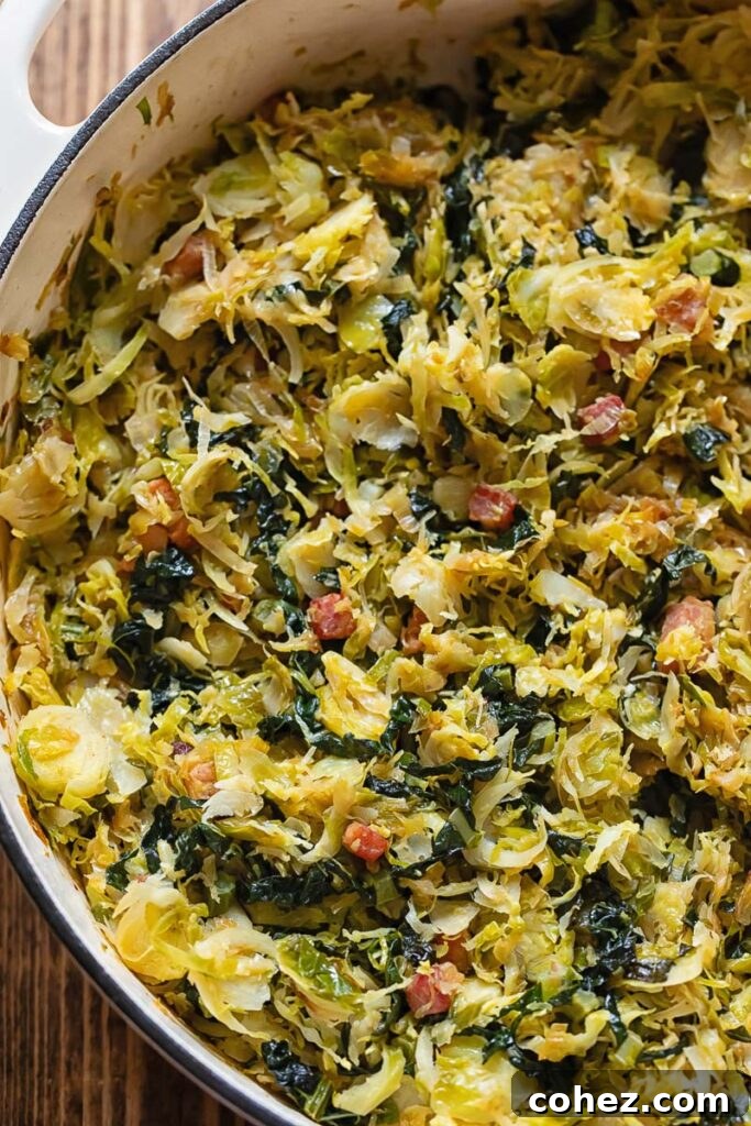 Close-up of golden-brown caramelized Brussels sprouts mixed with leeks and pancetta in a wide frying pan.