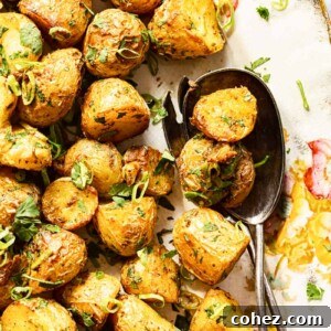 Perfectly spiced roasted baby potatoes, garnished with sliced green onions and fresh cilantro.