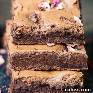 Stack of three rich, dark Turkish Delight Brownies, showing their fudgy texture.