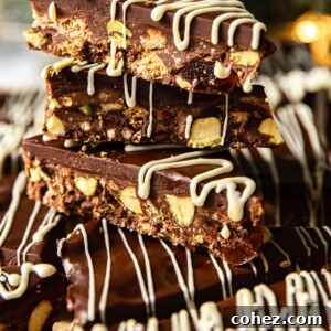 Chocolate fridge cake bars stacked neatly, revealing their chunky texture of biscuits and chocolate.