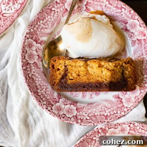 A large, inviting slow cooker cookie bar on a plate, garnished with ice cream and toffee sauce.