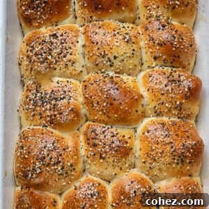 Top down shot of golden brown dinner rolls in a baking dish