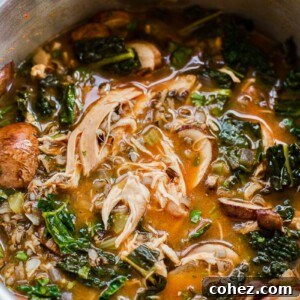 Thai chicken and wild rice soup cooking in a slow cooker, showing rich broth and ingredients.