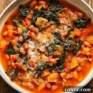 Close up shot of chorizo bean and veg soup in a bowl topped with Parmesan