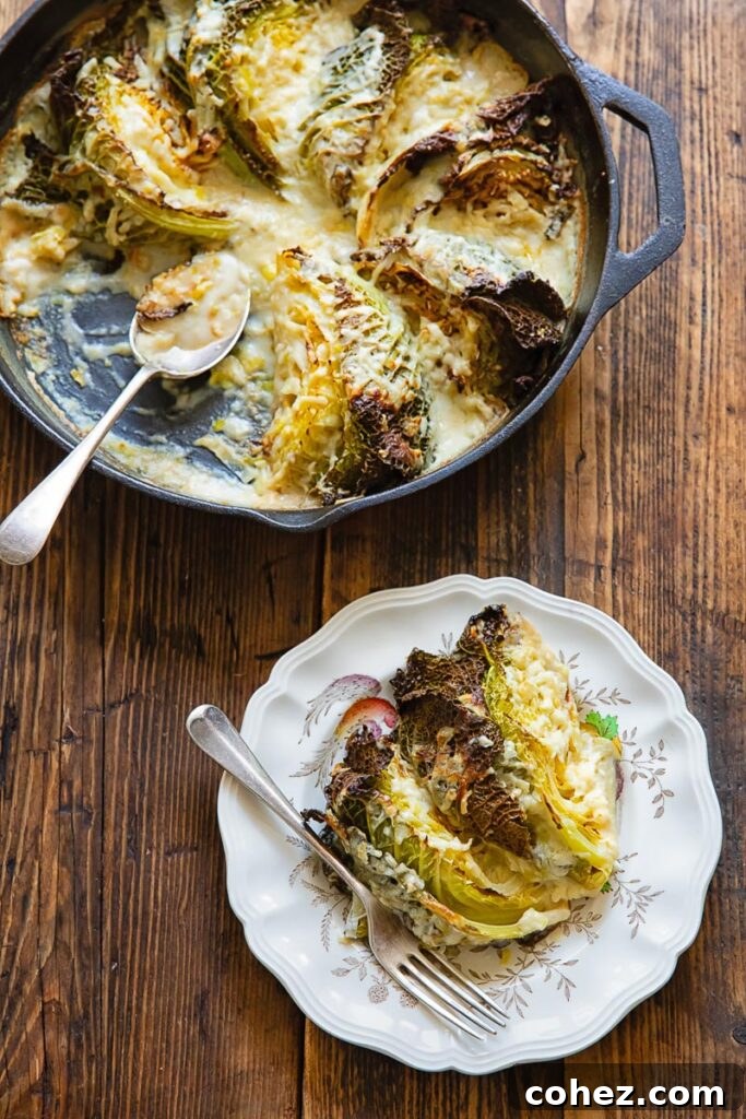 Savoy cabbage gratin in a skillet, with a piece removed to a side plate, on a wooden background, showing the creamy texture.