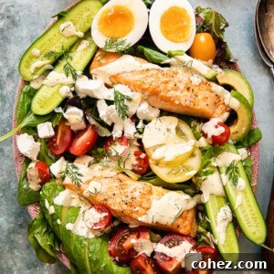 Top-down view of a vibrant Salmon Cobb Salad with eggs, avocado, and tomatoes