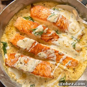 Tender salmon pieces in a creamy lemon dill sauce, garnished with fresh dill