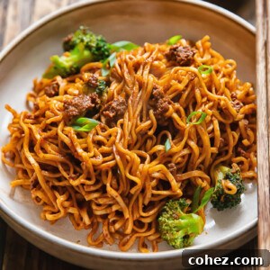 Side shot of gochujang noodles in a wide bowl on a table