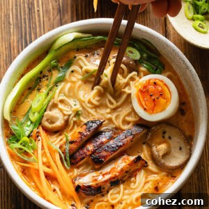 Top down shot of bowl of chicken ramen with chopsticks