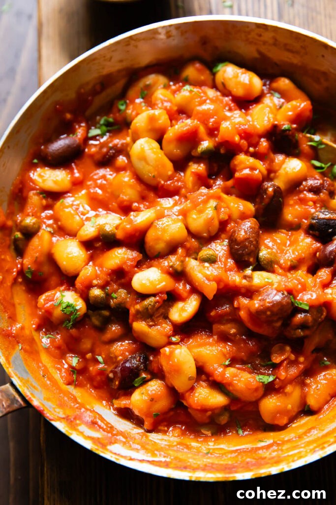 Close up of butter beans in puttanesca sauce