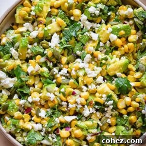 Top down shot of avocado and corn salad in a wide bowl