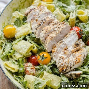 Pesto Pasta with sliced grilled chicken, cherry tomatoes and arugula.
