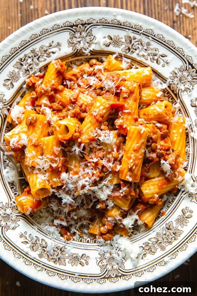 Top down shot of lentil bolognese sauce in a bowl of pasta