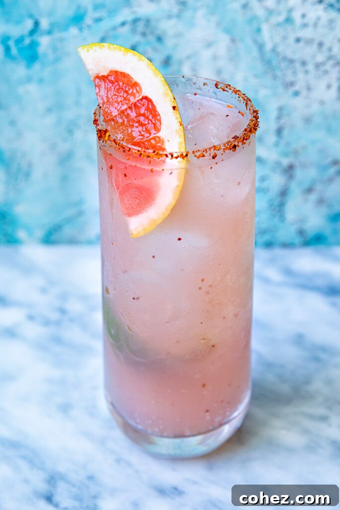 Close up shot of mezcal paloma in a tall glass
