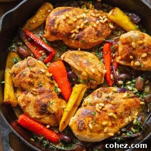 Top down shot of Mediterranean chicken in a pan with olives and peppers