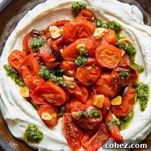 top down view of ricotta dipped topped with roasted cherry tomatoes and pesto