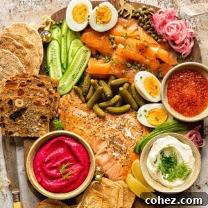 Top down view of grazing board made of smoked salmon, cucumbers, pickles and capers