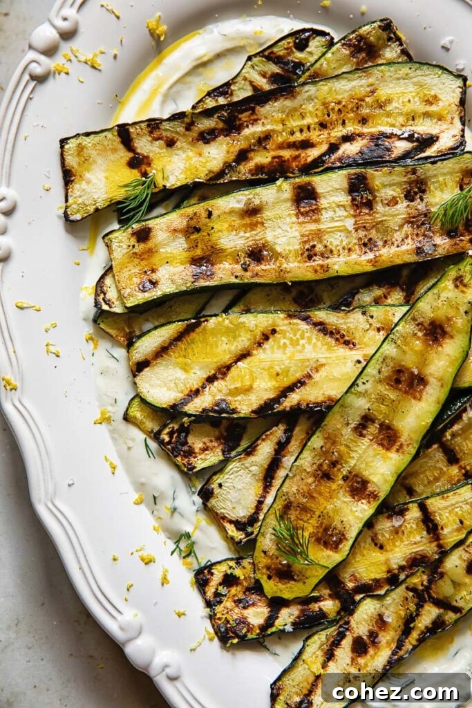 vertical shot of grilled zucchini on a bed of whipped feta